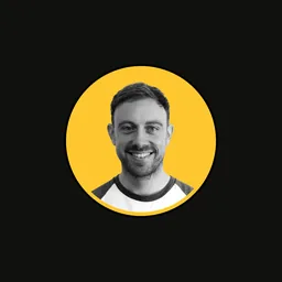 Headshot of James Jaggard on a gold circular backdrop.